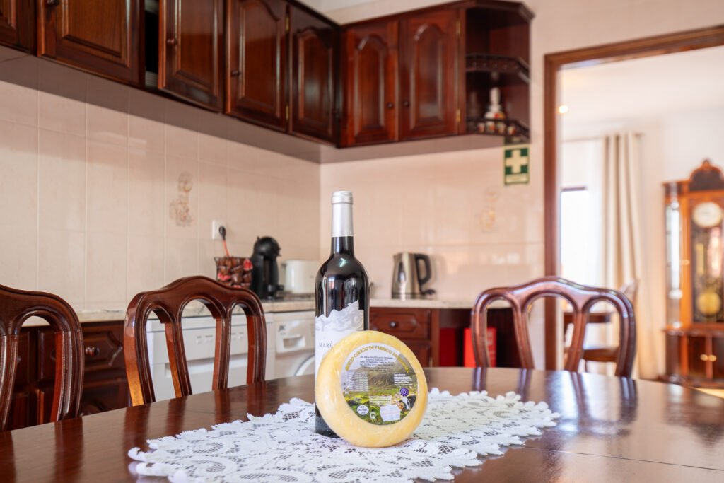 Fully equipped kitchen at Casa da Sogra with dishwasher, washing machine, and coffee maker with pods